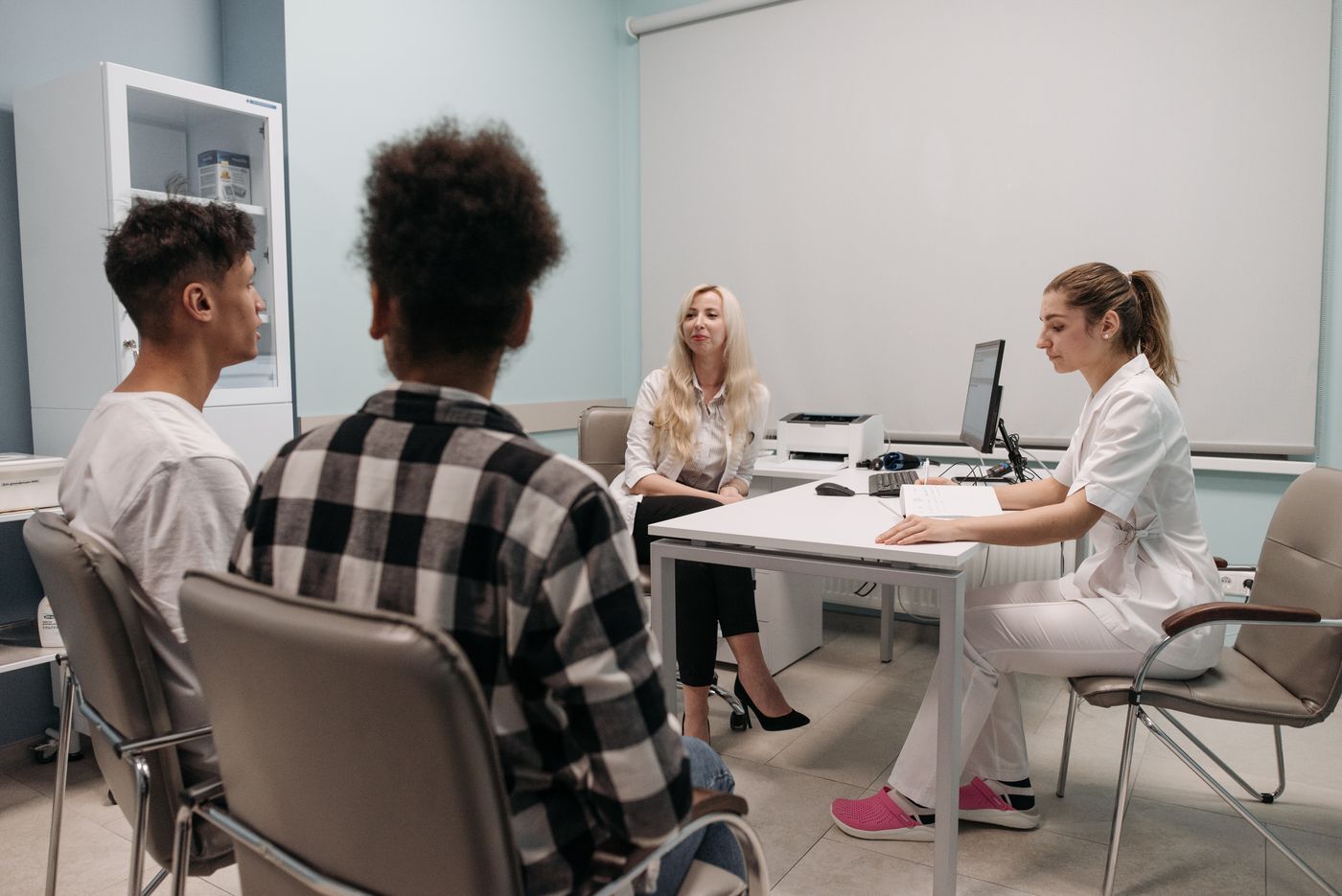 Doctors talking with patients during a medical appointment in a clinic