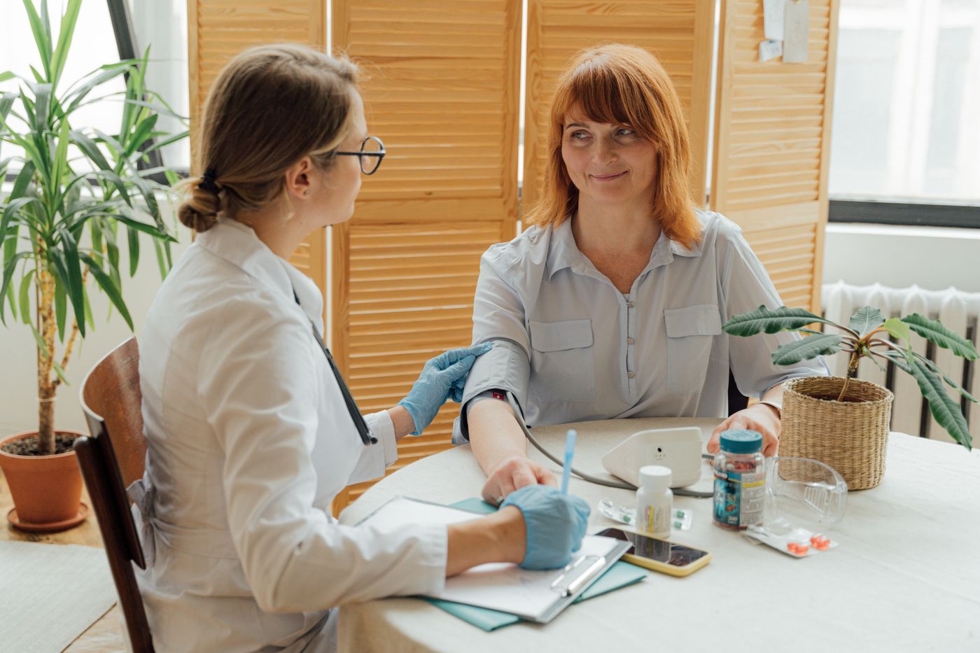 Doctor measuring a patient's blood pressure during a cardio health check