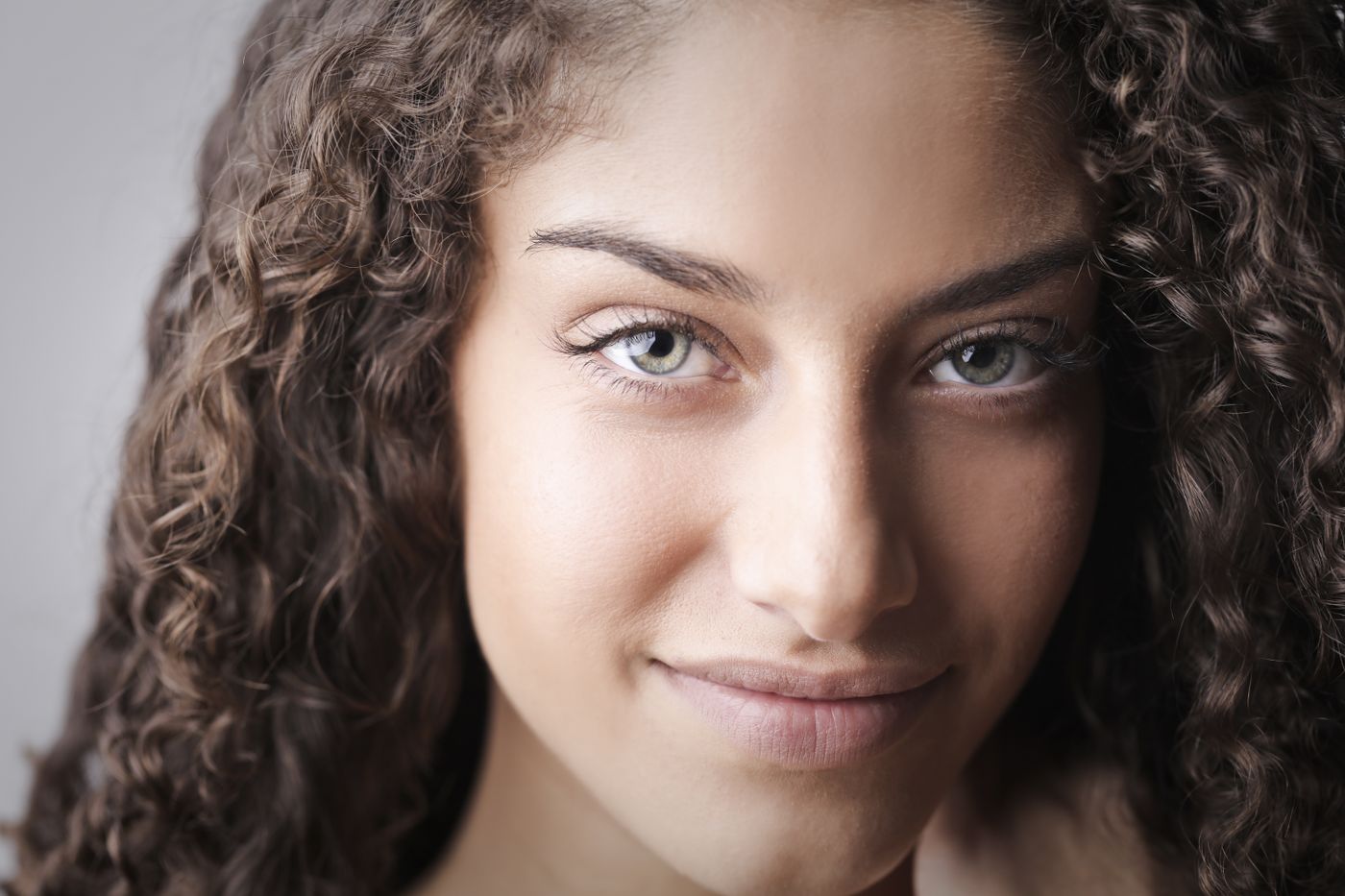 Glowing skin and healthy hair representing hair and skin treatment