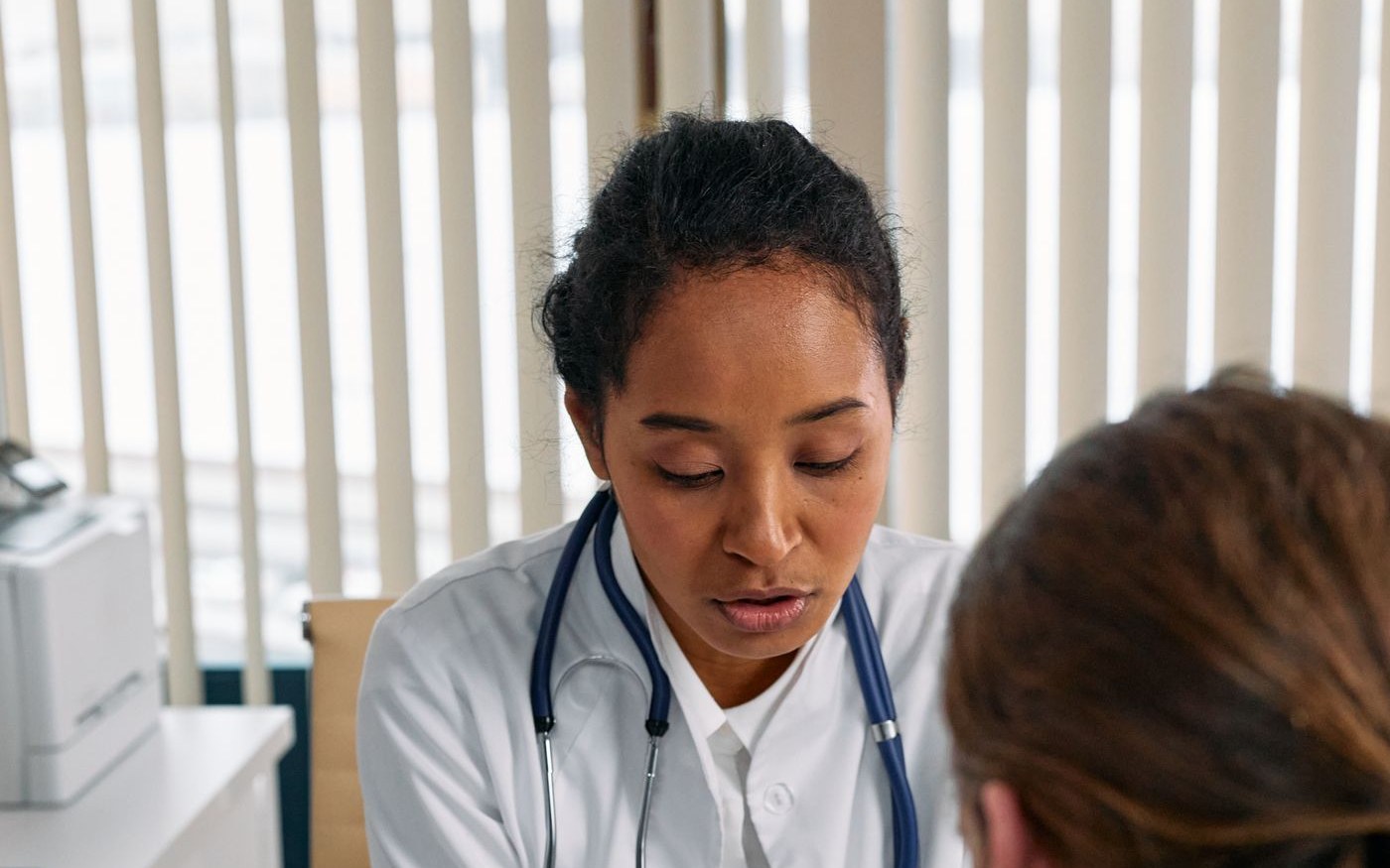 Doctor discussing a health chart with a patient during a consultation